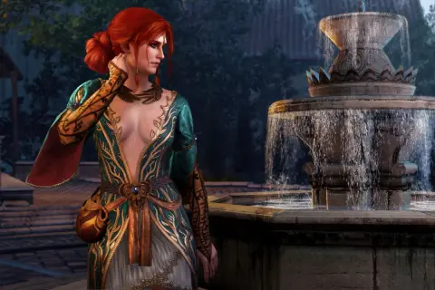 Triss Merigold w alternatywnym wyglądzie, w bogato zdobionej sukni, stoi obok kamiennej fontanny.